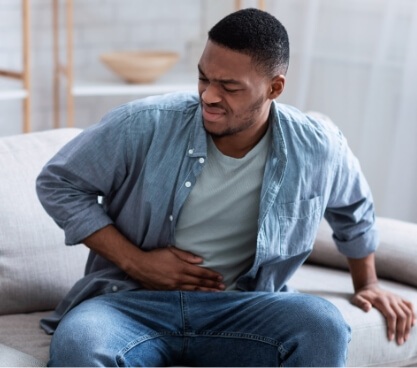 african-american-guy-having-stomachache-after-eati-2023-11-27-05-04-33-utc (1)